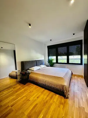 a bedroom with a large bed and a large window at Vracar-Luxury Penthouse in Belgrade