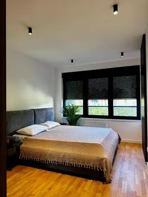 a bedroom with a bed and a couch at Vracar-Luxury Penthouse in Belgrade