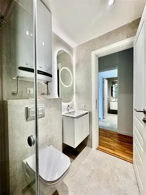 a bathroom with a toilet and a sink and a mirror at Vracar-Luxury Penthouse in Belgrade