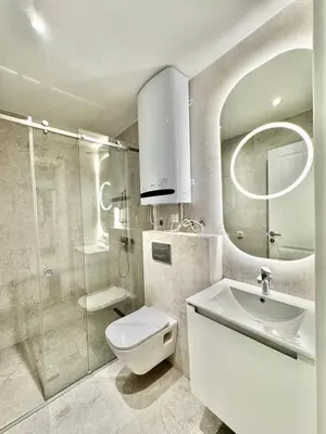 a bathroom with a toilet and a sink and a shower at Vracar-Luxury Penthouse in Belgrade