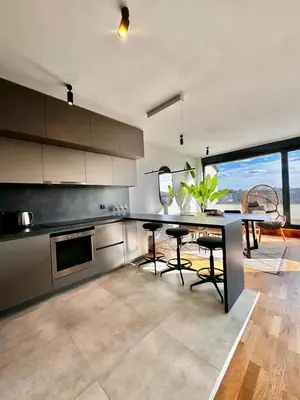 a kitchen with a table and some chairs in it at Vracar-Luxury Penthouse in Belgrade