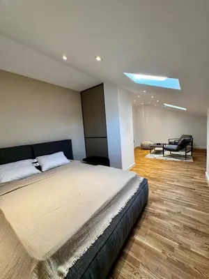 a bedroom with a bed and a chair in it at Vracar-Luxury Penthouse in Belgrade