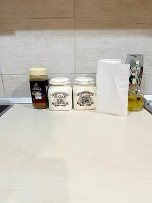 a counter with three jars of honey and a paper towel at Mara apartment, Belgrade, New belgrade in Belgrade