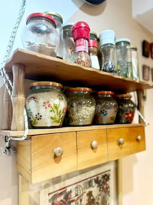 a wooden shelf with jars on top of it at Mara apartment, Belgrade, New belgrade in Belgrade