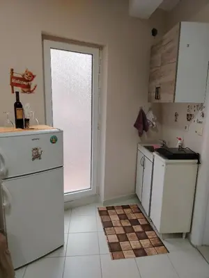 a kitchen with white appliances and a window at Apartman PRAMAC in Belgrade
