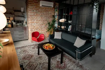 a living room with a couch and a bowl of fruit on a table at BGLAB Small Rooftop in Belgrade