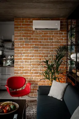 a living room with a couch and a brick wall at BGLAB Small Rooftop in Belgrade