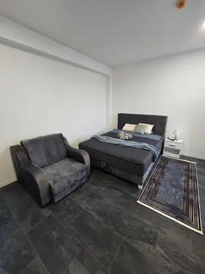 a bedroom with a bed and a chair at Stari Vuk in Belgrade
