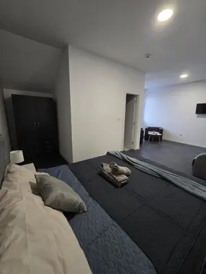 a bedroom with a bed with a pair of shoes on it at Stari Vuk in Belgrade