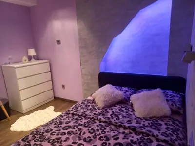 a bedroom with a purple bed with pillows on it at Perfect place to stay in Belgrade