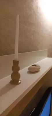 a white counter with a candle and a vase on it at Perfect place to stay in Belgrade