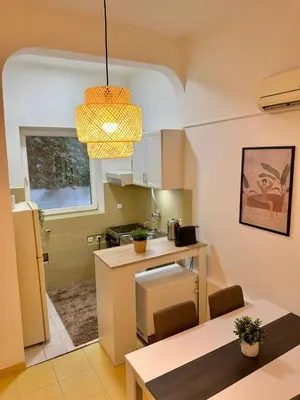 a small kitchen with a table and a dining room at Skadarlija Retro Charming Apartment in Belgrade