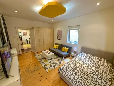 a bedroom with a bed and a couch in a room at Skadarlija Retro Charming Apartment in Belgrade