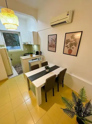 a kitchen and dining room with a table and chairs at Skadarlija Retro Charming Apartment in Belgrade