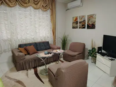 a living room with a couch and chairs and a tv at PRAMAC - stan na dan in Belgrade