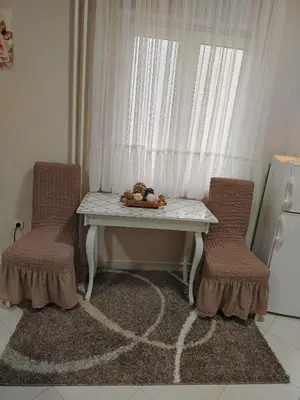 a table and two chairs in a kitchen with a window at PRAMAC - stan na dan in Belgrade