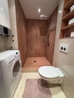a bathroom with a toilet and a washing machine at Studio Skadarlija in Belgrade