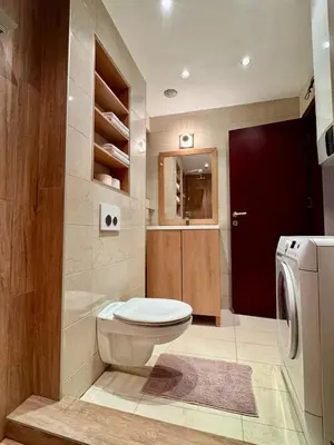 a bathroom with a toilet and a washing machine at Studio Skadarlija in Belgrade