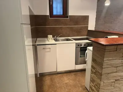 a kitchen with a sink and a stove at Studio Skadarlija in Belgrade