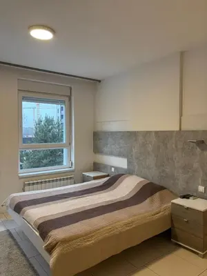 a bedroom with a large bed and a window at KAN Suites 2 in Belgrade