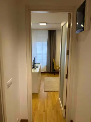 a hallway with a room with a desk and a window at Apartment Premier 3 Belville in Belgrade