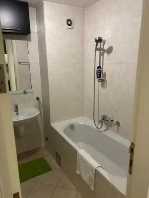 a bathroom with a bath tub and a sink at Apartment Premier 3 Belville in Belgrade