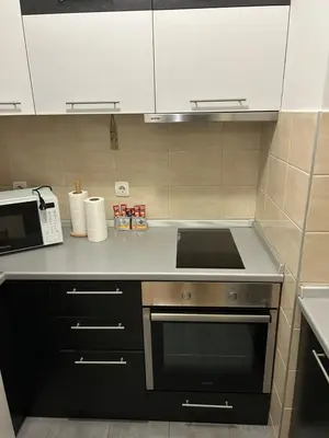 a kitchen with a stove and a microwave at Apartment Premier 3 Belville in Belgrade