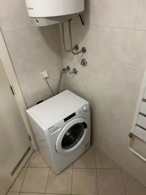 a washing machine in a corner of a bathroom at Apartment Premier 3 Belville in Belgrade