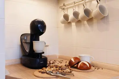 a kitchen counter with a coffee maker and some bread at Melody View with Balcony 2min to National Assembly in Belgrade