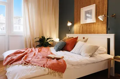 a bedroom with a bed with a book on it at Melody View with Balcony 2min to National Assembly in Belgrade