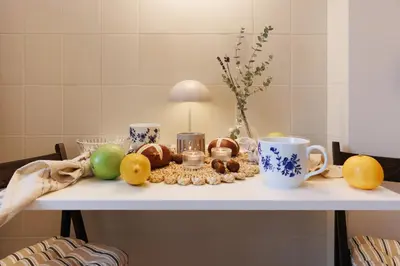 a table with fruits and cups on top of it at Melody View with Balcony 2min to National Assembly in Belgrade