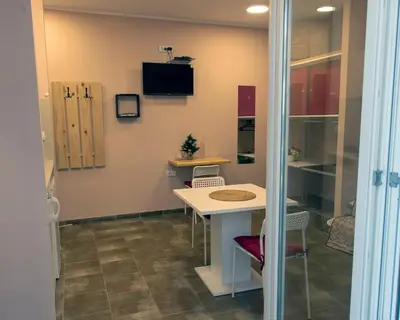 a room with a table and chairs in a room at Studio Anrora 2 in Belgrade