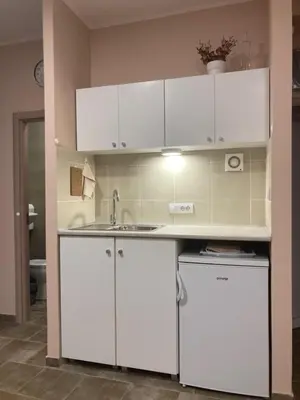 a kitchen with white cabinets and a sink at Studio Anrora 2 in Belgrade