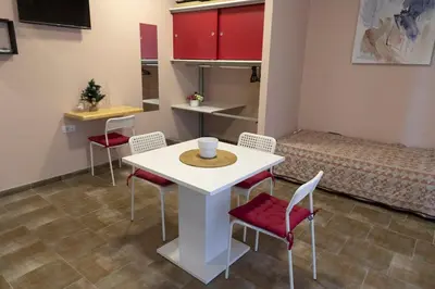 a room with a table and chairs and a bed at Studio Anrora 2 in Belgrade
