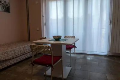 a room with a table and two chairs and a bed at Studio Anrora 1 in Belgrade