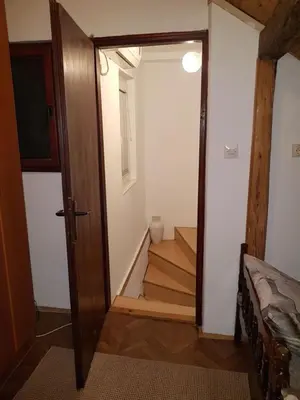 a hallway with a door open to a room with stairs at Ozon in Belgrade