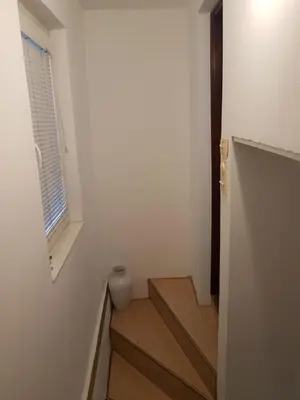 a hallway with stairs and a window in a house at Ozon in Belgrade