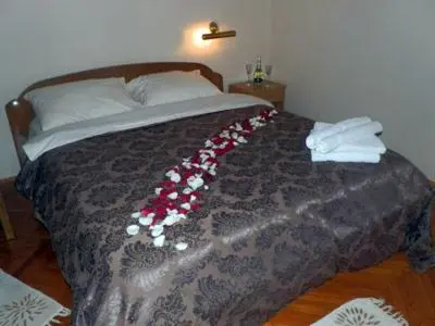a bed with a bunch of flowers on it at Hostel Mondeo in Belgrade