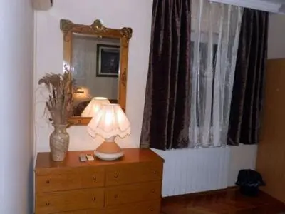 a lamp on a dresser in a room with a mirror at Hostel Mondeo in Belgrade