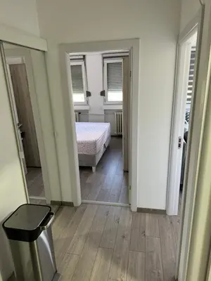 a room with a bedroom with a bed and a mirror at Marakana in Belgrade