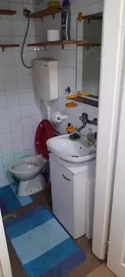 a bathroom with a toilet and a sink at Apartman Mikica in Pančevo