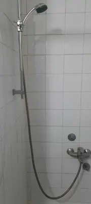 a shower with a hose in a bathroom at Apartman Mikica in Pančevo
