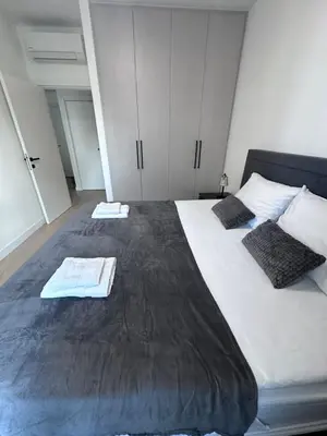 a bedroom with a large bed with two towels on it at Waterfront Belgrade Peaceful Nest Apartment in Belgrade