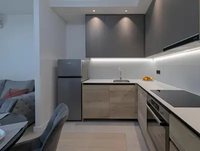 a kitchen with a sink and a refrigerator at Waterfront Belgrade Peaceful Nest Apartment in Belgrade