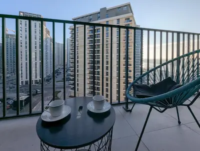 a table and a chair on a balcony with a view at Waterfront Belgrade Peaceful Nest Apartment in Belgrade