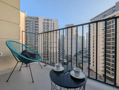 a table and a chair on a balcony with a view at Waterfront Belgrade Peaceful Nest Apartment in Belgrade
