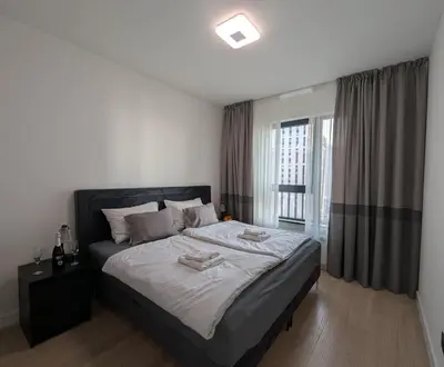 a bedroom with a large bed and a window at Waterfront Belgrade Peaceful Nest Apartment in Belgrade