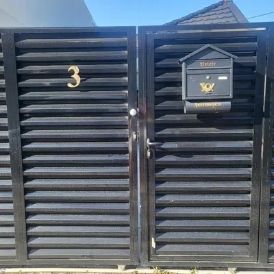 a gate with a sign on the side of a building at Jovanovic Residence Belgrad in Belgrade
