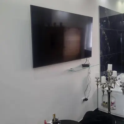 a flat screen tv hanging on a white wall at Jovanovic Residence Belgrad in Belgrade