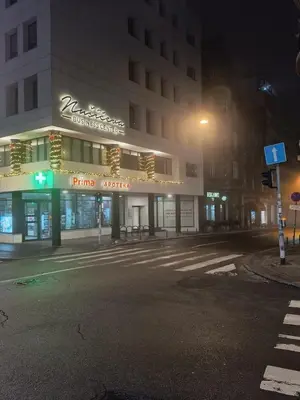 an empty street in front of a building at night at Rustic central in Belgrade